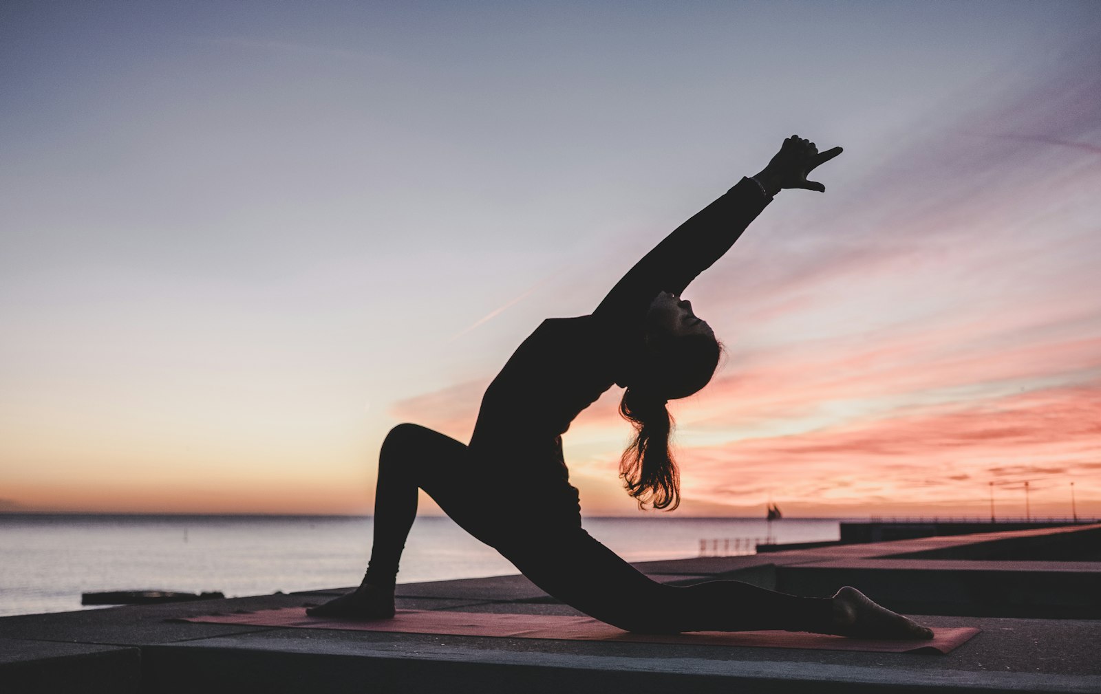 Quiet outdoor yoga stretch at soft evening light